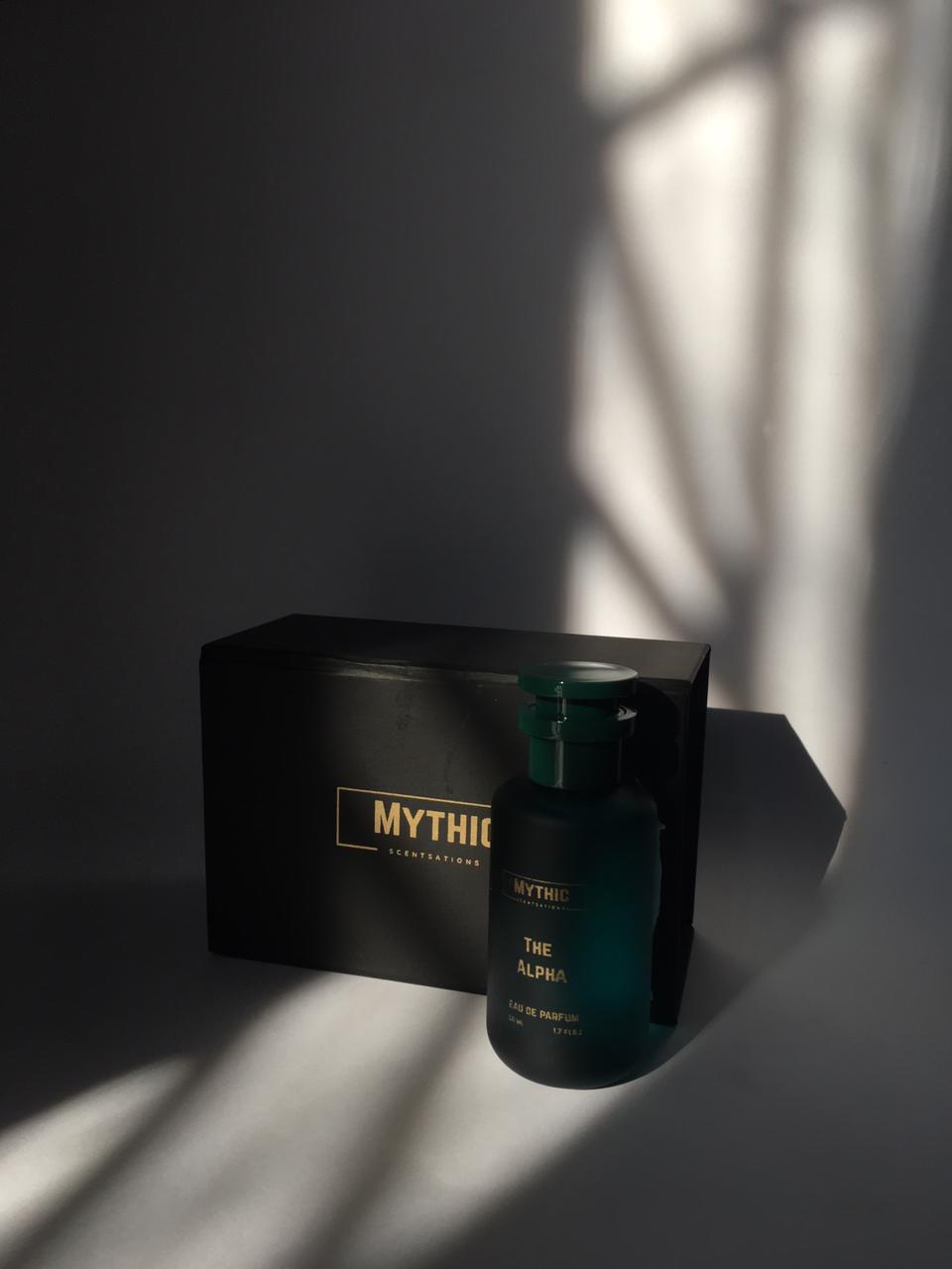 Dark green perfume bottle with 'Mythic' packaging on a dark background