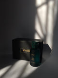 Dark green perfume bottle with 'Mythic' packaging on a dark background