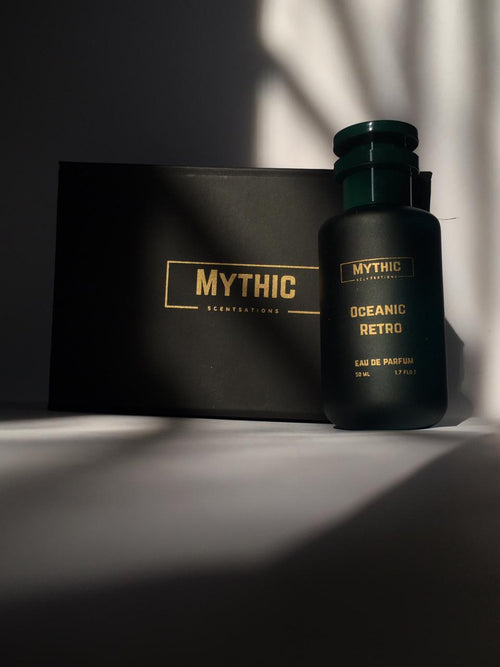 Black perfume bottle labeled 'Mythic' with a matching box on a dark surface.