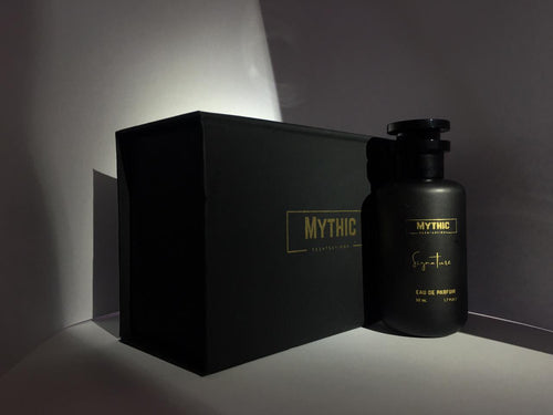Black 'Mythic' perfume bottle and packaging on a dark background