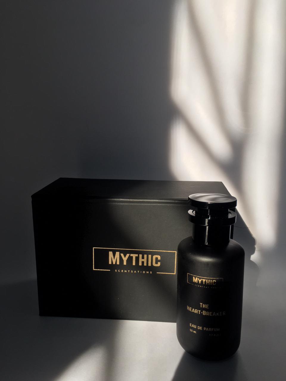 Black perfume bottle and packaging with 'Mythic' branding on a dark background.