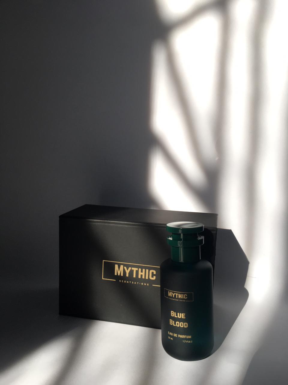 Perfume bottle labeled 'Blue Blood' by Mythic on a dark surface with a branded box.