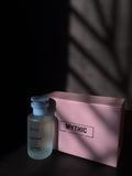 Mythic bottle and pink pouch on a dark background