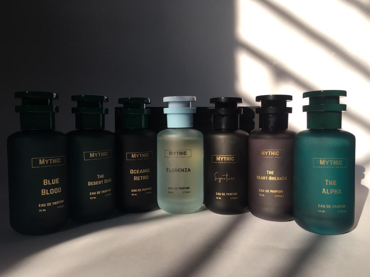 Collection of Mythic perfume bottles on a dark background